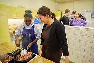 Senatorin Sandra Scheeres im Gespräch mit einer Teilnehmerin der Berliner Ferienschule, angeboten von Jugendsteg e.V., in der Lerngruppe „Kochen“.